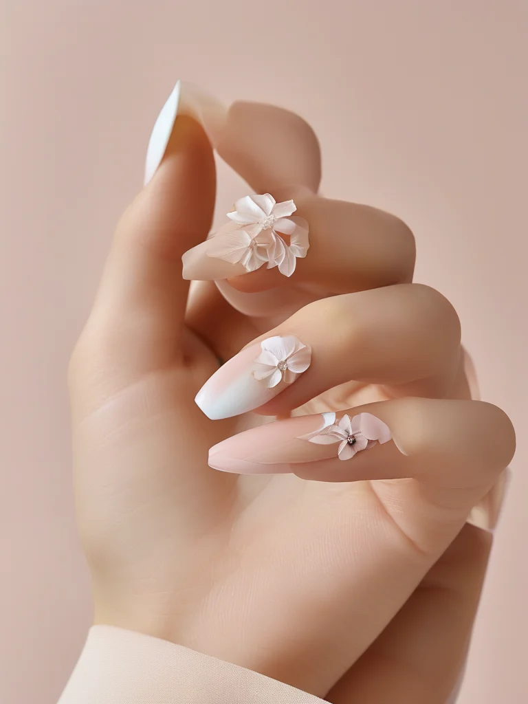 25+ Enchanting Korean Nail Art Ideas to Elevate Your Manicure Game 7 Almond-shaped nails in a soft matte blush pink feature delicate, raised white gel floral patterns sculpted onto accent nails, creating a subtle 3D embossed effect. Soft lighting accentuates the textured details.