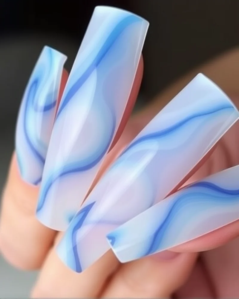 7 Beach Nail Art Designs That Are Trending This Summer 2 Coffin-shaped nails with 3D gel ocean waves in shades of white, indigo, and seafoam green.