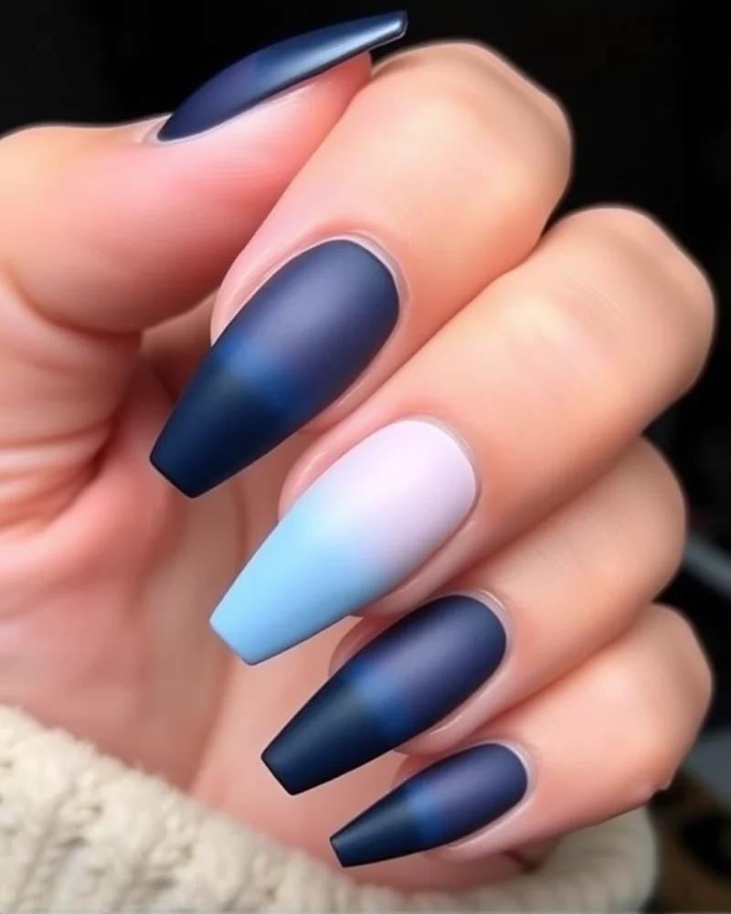 Coffin nails showing a smooth gradient from navy blue to sky blue with a matte texture.