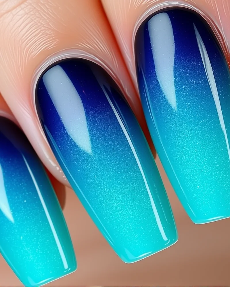 Shark Week Nails: 7 Fierce Designs to Make a Splash This Season 3 Long coffin-shaped nails with a deep sea ocean gradient.