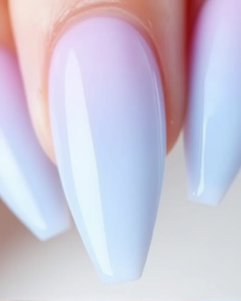 Stiletto shaped nails with a soft pastel ombre transition.