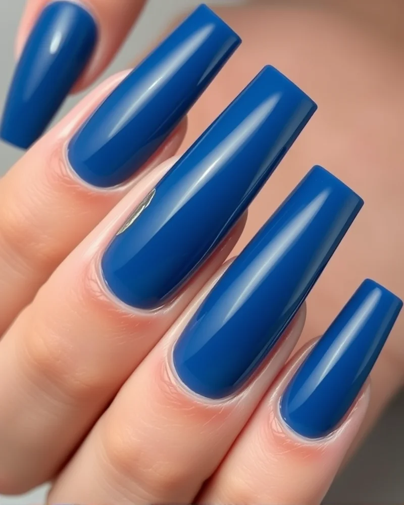 10 Trendy Nails for August: The Ultimate Guide to Late Summer Manicures 6 Deep ocean blue jelly gel nails for August with gold leaf accents.