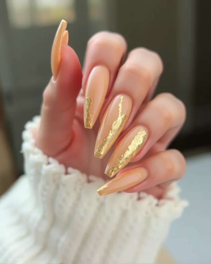 7 Luxurious Nails for Fall Trends That Define Autumn Elegance 8 Nude nails with gold foil accents for fall