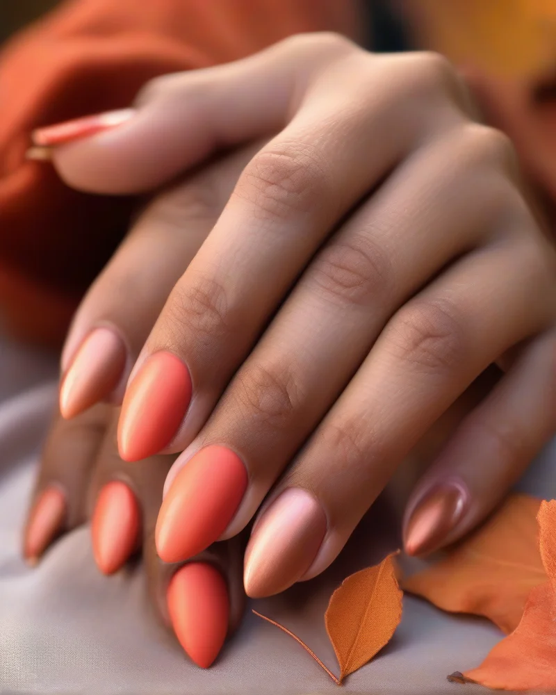 Nail Inspo September 7 A close-up view of a professional manicure transitioning from bright summer coral to fall copper, featuring a matte top coat and glitter accent nails for a seasonal update.